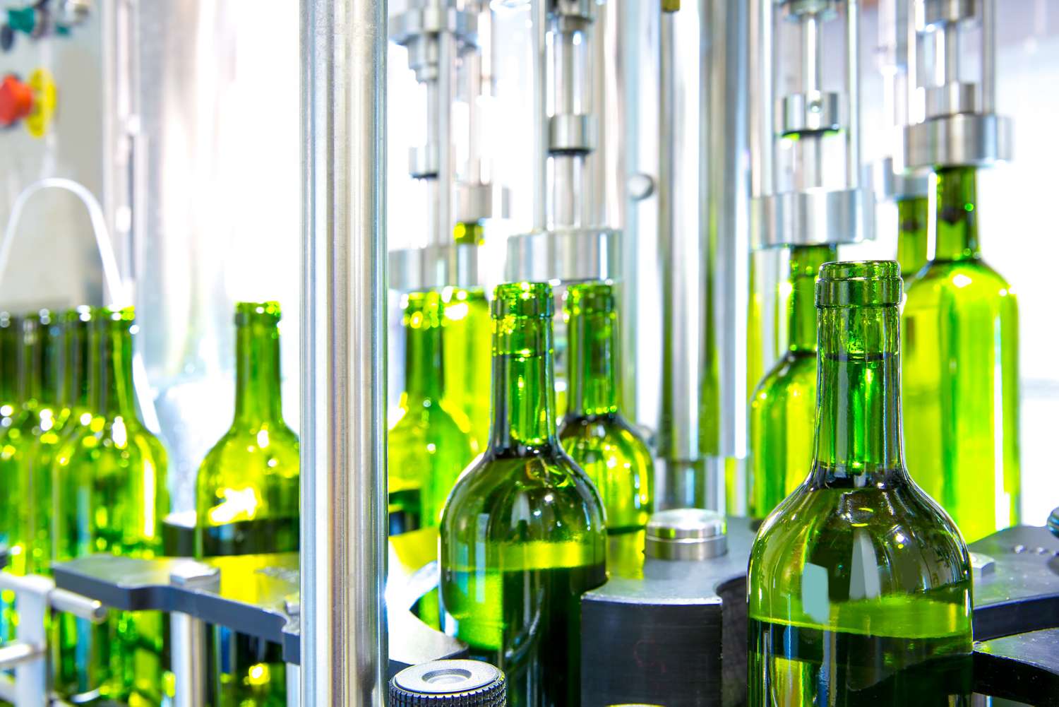 white wine in bottling machine at winery